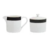 A white sugar bowl with a lid and a white creamer pitcher, both with a black band and a thin gold trim, are displayed against a white background. Podgląd zdjęcia produktu