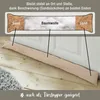 A fabric draft stopper filled with sand and cotton, shown on a wooden floor in front of a white door. Produktbild-Vorschau