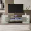 A modern TV stand with a large television mounted above it, illuminated with blue LED lights. Náhled obrázku produktu