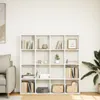 A white bookshelf filled with books and decorative items, placed against a white wall. Produktbild-Vorschau