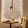 A pendant light hangs above a small round table with a croissant and a cup of coffee, next to a chair draped with a blanket, with a snowy window in the background. Produktbild-Vorschau
