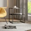 A modern living room scene with a yellow armchair and a black metal side table. Náhled obrázku produktu