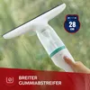 A hand holding an electric window cleaner against a wet window. Produktbild-Vorschau