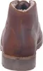 A close-up rear view of a brown leather boot with a shearling lining. Voir les images du produit