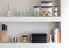 Kitchen shelves with various items including storage containers, glasses, knives, a bread bin, and books. Podgląd zdjęcia produktu