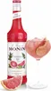 A bottle of Monin Pink Grapefruit syrup and a glass of pink grapefruit drink. Podgląd zdjęcia produktu