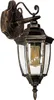 A classic outdoor wall lantern with a gold and bronze finish and clear glass panels. Voir les images du produit