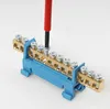 A close-up shot of a terminal block with a screwdriver tightening a screw. Produktbild-Vorschau