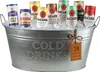 A galvanized metal tub filled with ice and various cans of drinks, including Bombay, Gordons, and Bacardi. Voir les images du produit