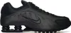 A studio shot of a single black Nike Shox R4 sneaker against a white background. Produktbild-Vorschau