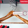 Two wooden clothes hangers hanging from a closet rod. Produktbild-Vorschau