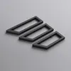 Three black wall consoles are arranged diagonally on a gray surface. Produktbild-Vorschau