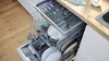 An open dishwasher filled with dishes. Produktbild-Vorschau