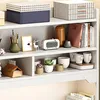 Shelves filled with decorative items and storage boxes. Náhled obrázku produktu