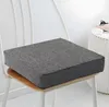 A dark gray seat cushion on a white chair. Produktbild-Vorschau