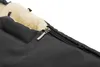 A close-up view of a black stroller footmuff with a zipper and a fluffy cream-colored lining. Náhľad obrázku produktu
