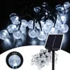A string of solar-powered LED lights with a solar panel. Produktbild-Vorschau