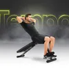 A man is performing a sit-up exercise on a black adjustable workout bench. The background features a dark, smoky atmosphere with bright yellow neon text that appears to spell out 'Tempo'. Náhľad obrázku produktu