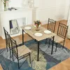 A dining set with a table and four chairs placed on a rug in front of a fireplace. Náhled obrázku produktu