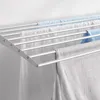 A close-up view of a wall-mounted drying rack with laundry hanging on it. Produktbild-Vorschau