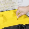 A hand is shown reaching into a yellow compartment of a black and yellow storage case. Produktbild-Vorschau