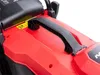 A close-up view of the top of a red lawnmower, focusing on a black carrying handle. Produktbild-Vorschau