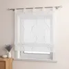 A white sheer curtain with green wavy embroidery and small beads is hung on a window. A small vase with lavender and a white decorative object are on a wooden surface to the left. Produktbild-Vorschau
