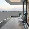 A balcony with outdoor furniture and a grey privacy screen. Produktbild-Vorschau