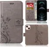 A collage of images showing a grey flip phone case with a floral and butterfly design, with some images showing the inside of the case with card slots and a phone. Produktbild-Vorschau