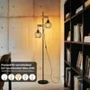 A modern living room with a concrete wall and a bookshelf. Produktbild-Vorschau
