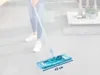 A person is using a mop on a tiled floor, with furniture and decor visible in the background. Produktbild-Vorschau