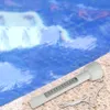 A white pool thermometer floats on the edge of a pool next to the water. Produktbild-Vorschau