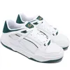 A pair of white Puma sneakers with green accents. Produktbild-Vorschau