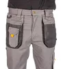 Close-up of the front of gray work pants with multiple pockets. Náhled obrázku produktu