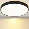 A close-up view of a black and white LED ceiling light mounted on a white ceiling. Produktbild-Vorschau