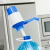 A manual water dispenser pump attached to a large water bottle in a kitchen setting. Produktbild-Vorschau