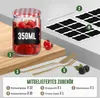 A set of glass jars with lids, accessories, and labels are displayed on a wooden surface. Produktbild-Vorschau
