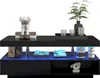 A black high-gloss coffee table with LED lighting, decorated with various items. Anteprima dell’immagine prodotto