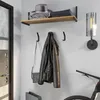 An entryway or hallway setting with a shelf and coat hooks. Produktbild-Vorschau