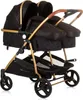A studio shot of a black and gold double stroller against a white background. Produktbild-Vorschau