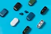 A collection of wireless earbuds and their charging cases arranged on a blue background. Náhľad obrázku produktu