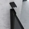 A close-up view of a black shower door frame and a detached black cap against a textured gray wall. Produktbild-Vorschau