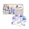 A product shot of a Tommee Tippee Closer to Nature newborn starter set, featuring baby bottles, teats, and a bottle brush, with a lifestyle image of a family in the background on the packaging. Voir les images du produit