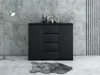 A black dresser with four drawers and two cabinets is shown in a modern room with a concrete wall and a floor lamp. Produktbild-Vorschau