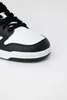 A close-up, studio shot of the toe of a black and white sneaker against a plain white background. Podgląd zdjęcia produktu