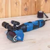 A sanding tool with a blue and black rotary tool and a sanding drum attachment sits on a wooden surface. Produktbild-Vorschau