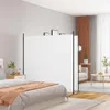 A bedroom scene with a white room divider set up between a bed and a living area. Náhled obrázku produktu