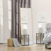 A bedroom scene with a full-length mirror, bedside tables with lamps, a basket with a blanket, and a bed. Náhled obrázku produktu