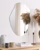 A decorative mirror is displayed on a wall above a wooden dresser, with various decorative items placed on the dresser. Náhled obrázku produktu