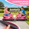Two children are riding pink bumper cars in a garden. Náhľad obrázku produktu